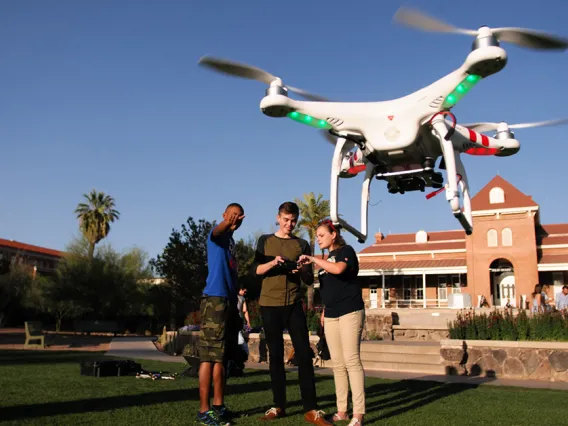 Students flying a drone near UA Main.