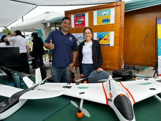 Photo of Napoleón Gudiño-Elizondo and Alma Anides Morales in front of aerial craft