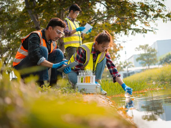 Students collecting water samples.