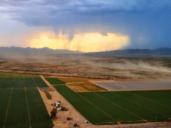 clouds over a field before a rain downpour